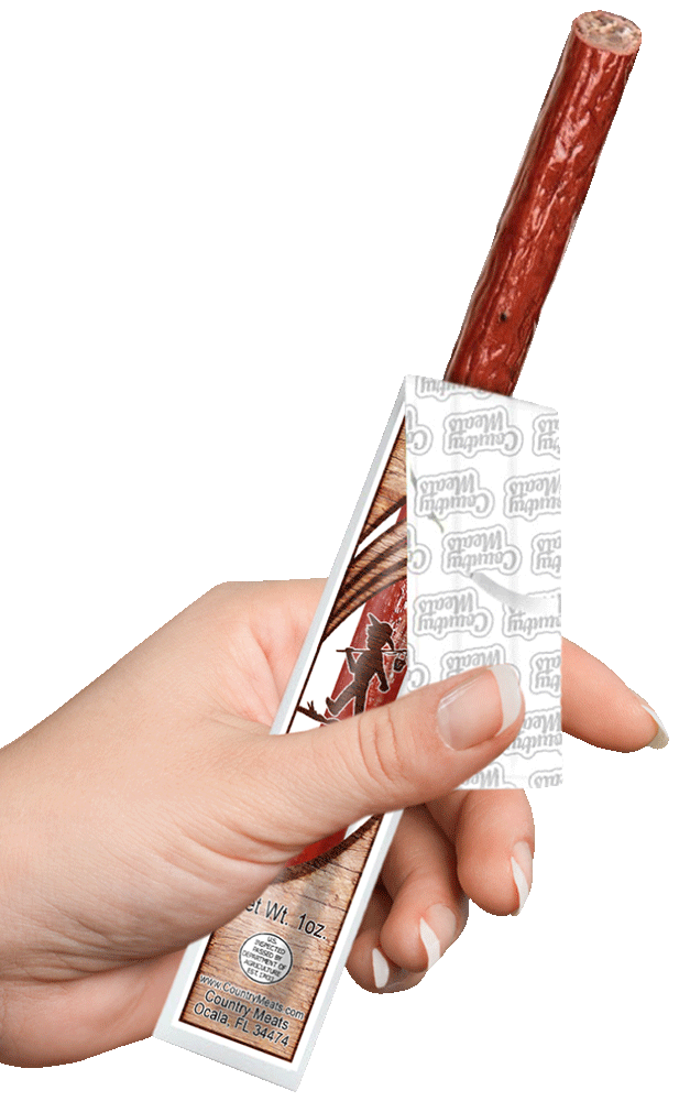 Hand holding Country Meats snack stick